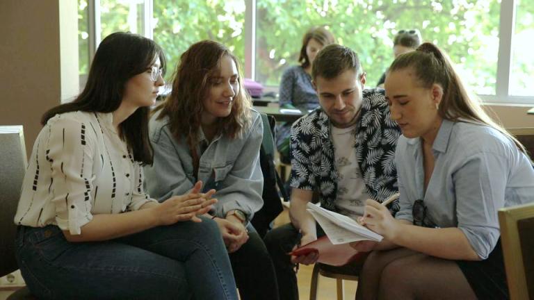 young women having a discussion at a workshop